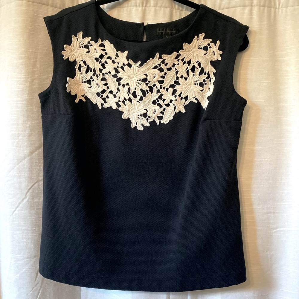 Black top with white floral appliqué. Size petite M